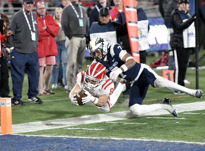 Mater Dei's Jack Ressler leaps for the goal line while defended by St. John Bosco's Peyton Woodyard during the teams' second meeting of 2022.